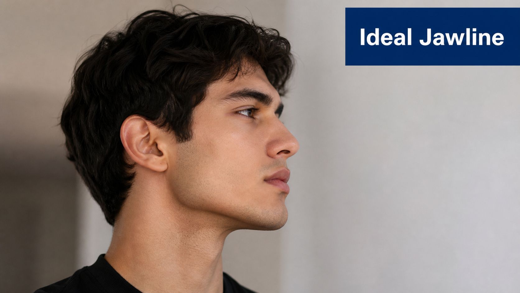 A close-up profile view of a young man with a defined and sharp jawline