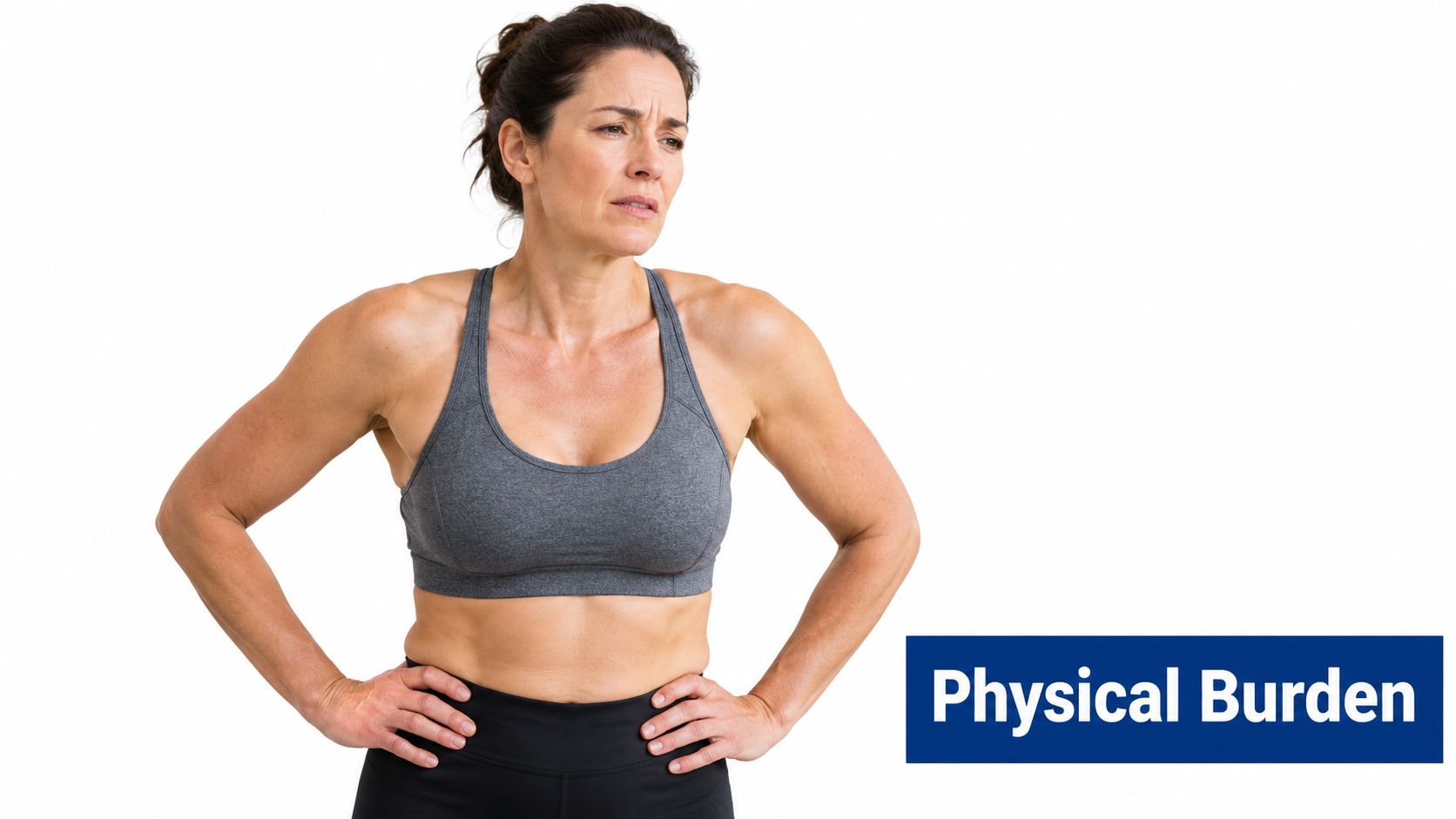 A woman in athletic wear stands with hands on her hips, appearing tired or experiencing physical discomfort.